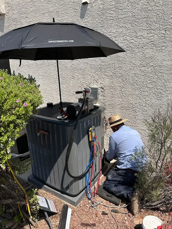 HVAC technician performing outdoor AC maintenance in Winder